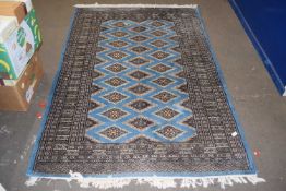 Modern floor rug decorated with geometric design on a pale blue background