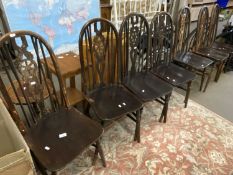 Seven wheel backed kitchen chairs