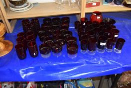 Large suite of mid 20th Century red glass ware to include wine glasses, tumblers and others