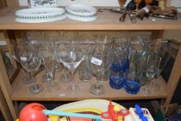 Quantity of assorted drinking glasses to include champagne flutes, cocktail glasses, wine glasses,