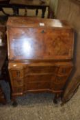 Queen Anne revival walnut veneered bureau raised on cabriole legs, 57cm wide