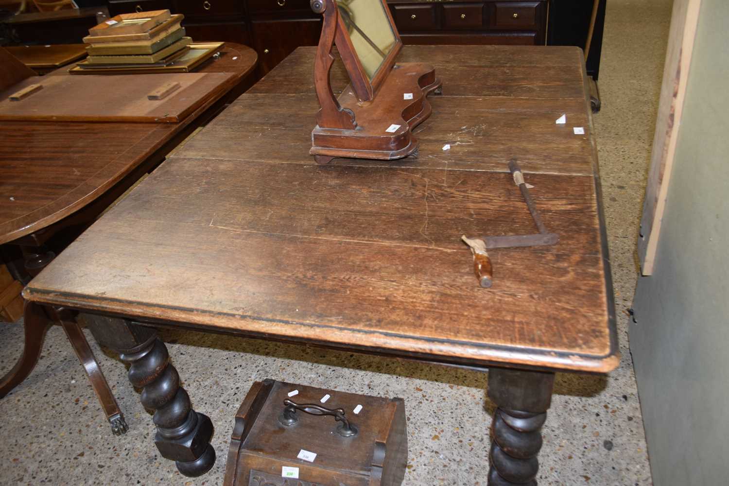 An early 20th Century oak dining table raised on barley twist legs, 146cm wide