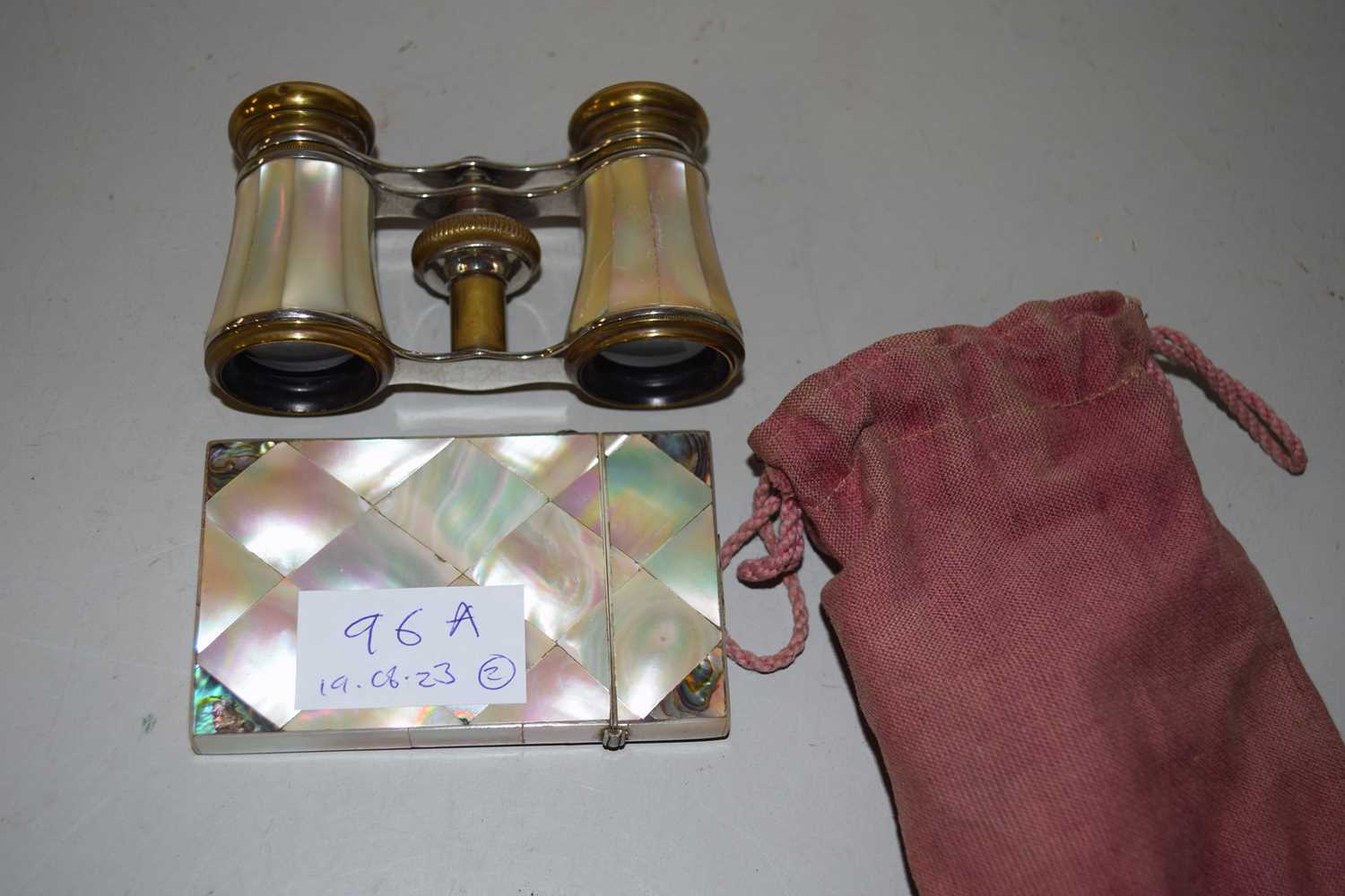 Mother of pearl card case and a mother of pearl and brass pair of opera glasses