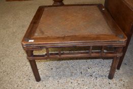 An Oriental square coffee table, the centre inset with a woven panel, 86cm wide