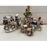 A group of seven various Staffordshire flat back figures and spill vases to include a pair of