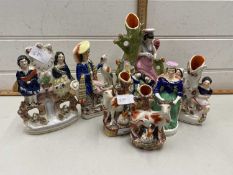 A group of seven various Staffordshire flat back figures and spill vases to include a pair of