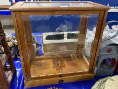 A glazed table top cabinet formerly housing precision scales