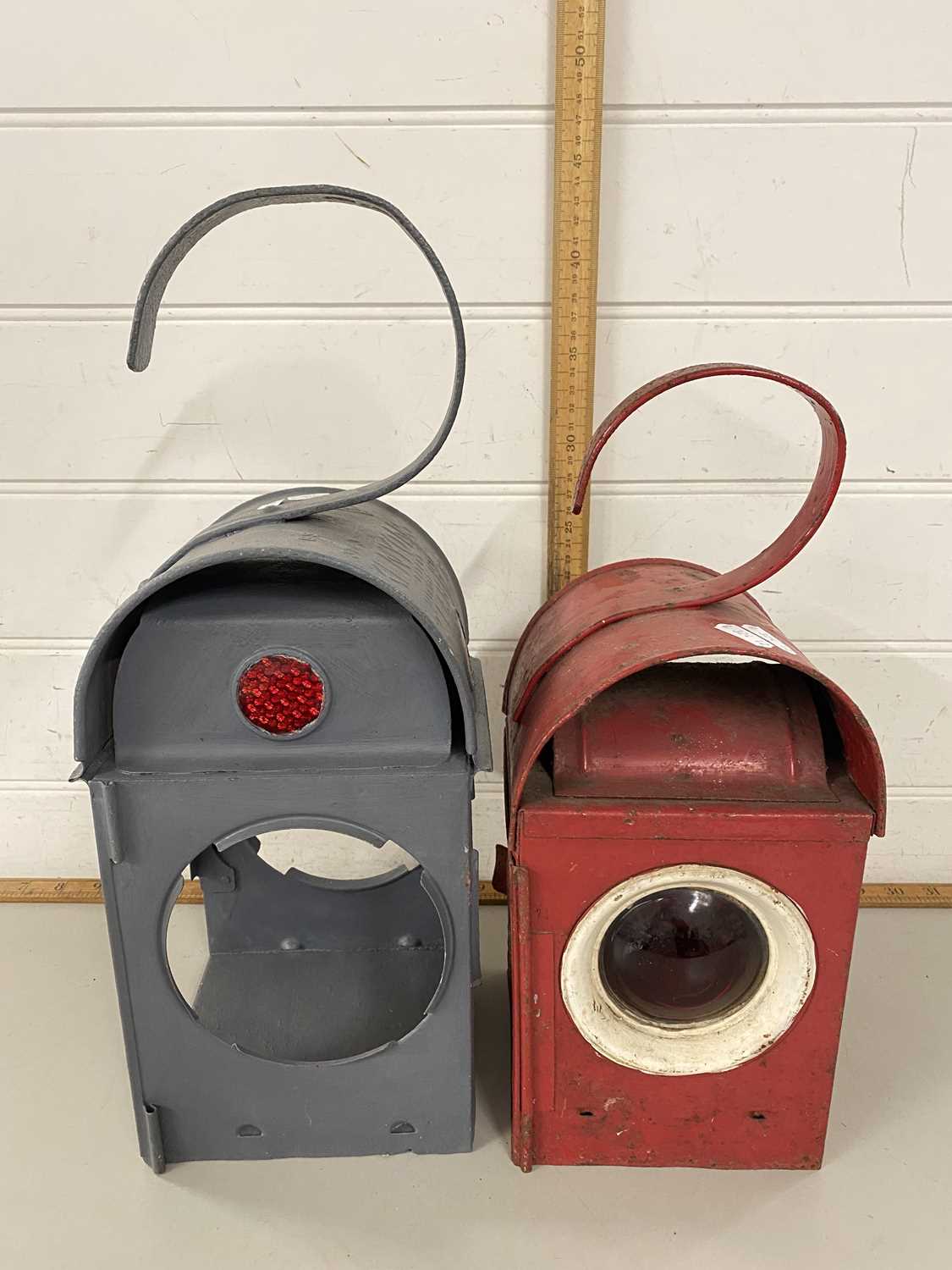 Two vintage railway lamps, the red example marked Greenham, the grey example marked Kenyons 72