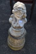 Concrete bust of a lady with flower in her hair raised on a plinth base