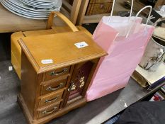 Fold out wooden sewing box together with a wooden jewellery cabinet and a quantity of napkin rings