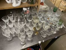 Large quantity of assorted drinking glasses to include liqueur glasses, wine glasses, brandy