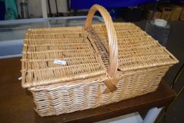 Wicker picnic hamper and a photographic print of a boating scene