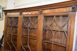 CONCAVE TRIPLE FRONT GLAZED BOOKCASE OF THREE GLAZED PANELS ABOVE AND CUPBOARDS BELOW, APPROX