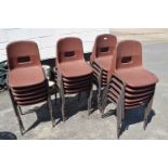 Quantity of brown plastic and metal framed stacking chairs, approx 24