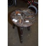 Small three legged stool with carved floral decoration