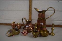 Group of copper jugs and brass candlesticks