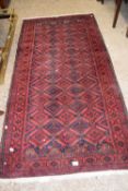 A red ground rug, approx 204cm long