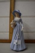 A Doulton style figure of a lady in blue