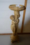 Resin plant stand modelled as a classical cherub on circular base