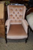 Wing back armchair with pink button back upholstery