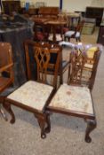 Pair of mahogany dining chairs with fret carved backs, cabriole legs and bun feet
