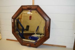 An oak framed octagonal wall mirror