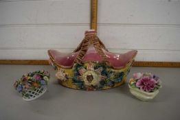 A pottery basket with two Dresden style small models of flowers