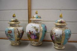 Group of three Dresden porcelain vases and covers decorated in Meissen style