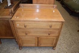An oak chest of drawers of two long and cupboards below, 84cm wide
