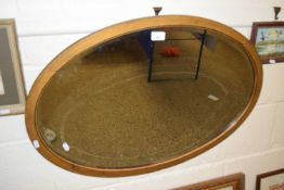 Oval mirror in wooden frame