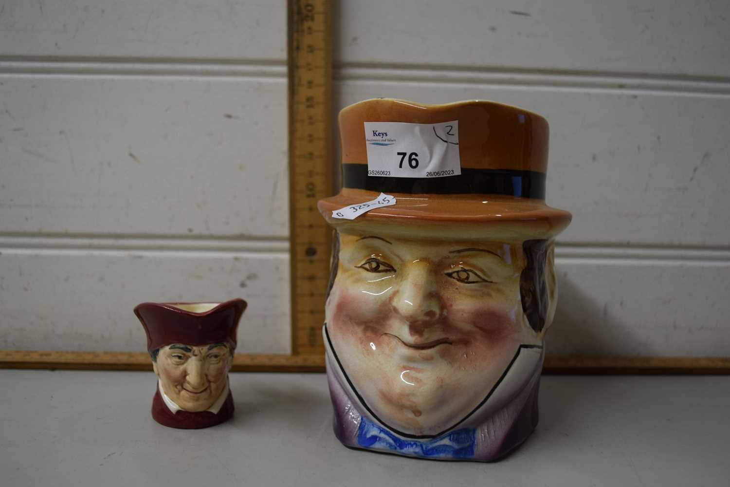 A character jug together with a small Doulton character jug