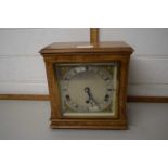 A maple veneered wall clock with chrome and brass finish dial