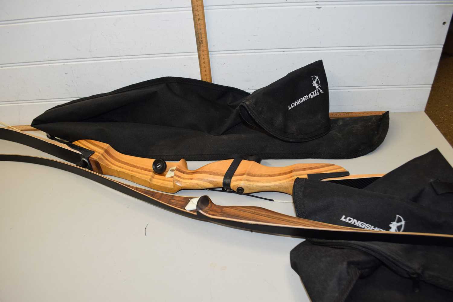 A Huwairen archers bow with carry case together with a Core Archery Pulse 64-68 inch archers bow,