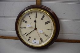 A wooden and brass framed wall clock