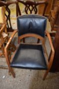 A faux leather seated elbow chair