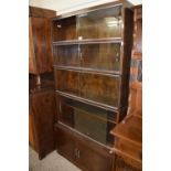 Bookcase with three glazed upper sections, a double tier four section and cupboards below with