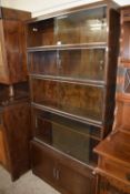 Bookcase with three glazed upper sections, a double tier four section and cupboards below with