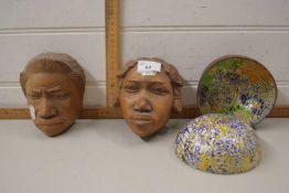 A pair of African style carved wooden heads together with a pair of decorated coconut bowls