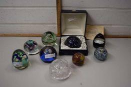 Eight assorted glass paperweights to include Caithness