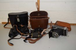 Two pairs of binoculars and a Welta camera, cased