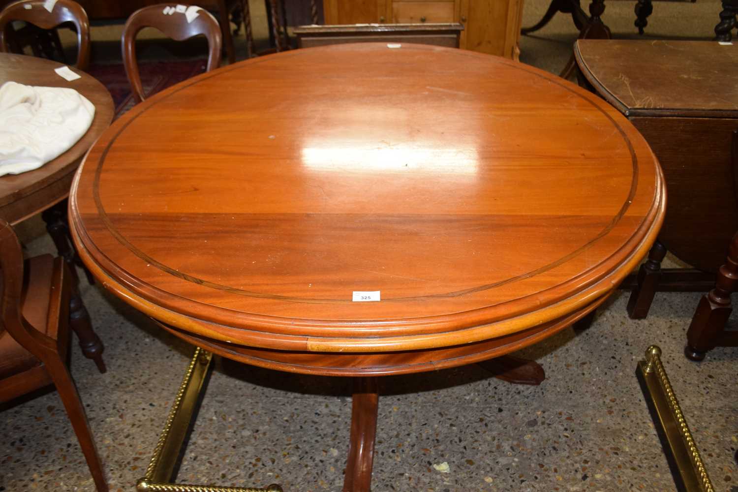 20th Century dark wood pedestal dining table with circular top over a four footed base, 120cm