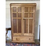 A oak double fronted wardrobe with two doors and drawer below, 119cm wide