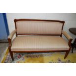 An oak framed open armed sofa with pink and green striped upholstery, approx 153cm wide