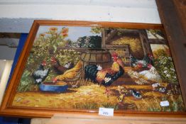 A framed embroidery picture of chickens