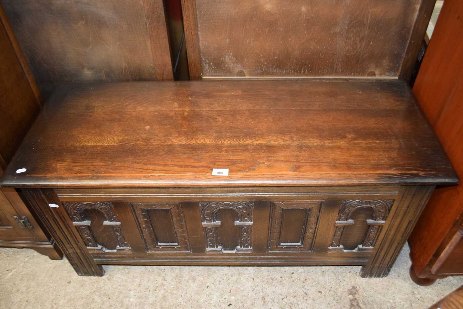 Reproduction pine coffer with carved front, approx 114 wide