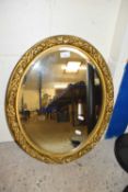 Large oval hall mirror in gilt frame
