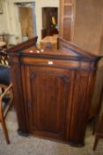 Oak corner cupboard with carved columns to either side raised pediment, 94cm wide