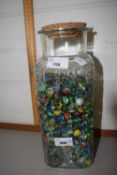 Large jar containing a quantity of marbles