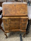 Queen Anne revival walnut veneered bureau raised on cabriole legs, 57cm wide