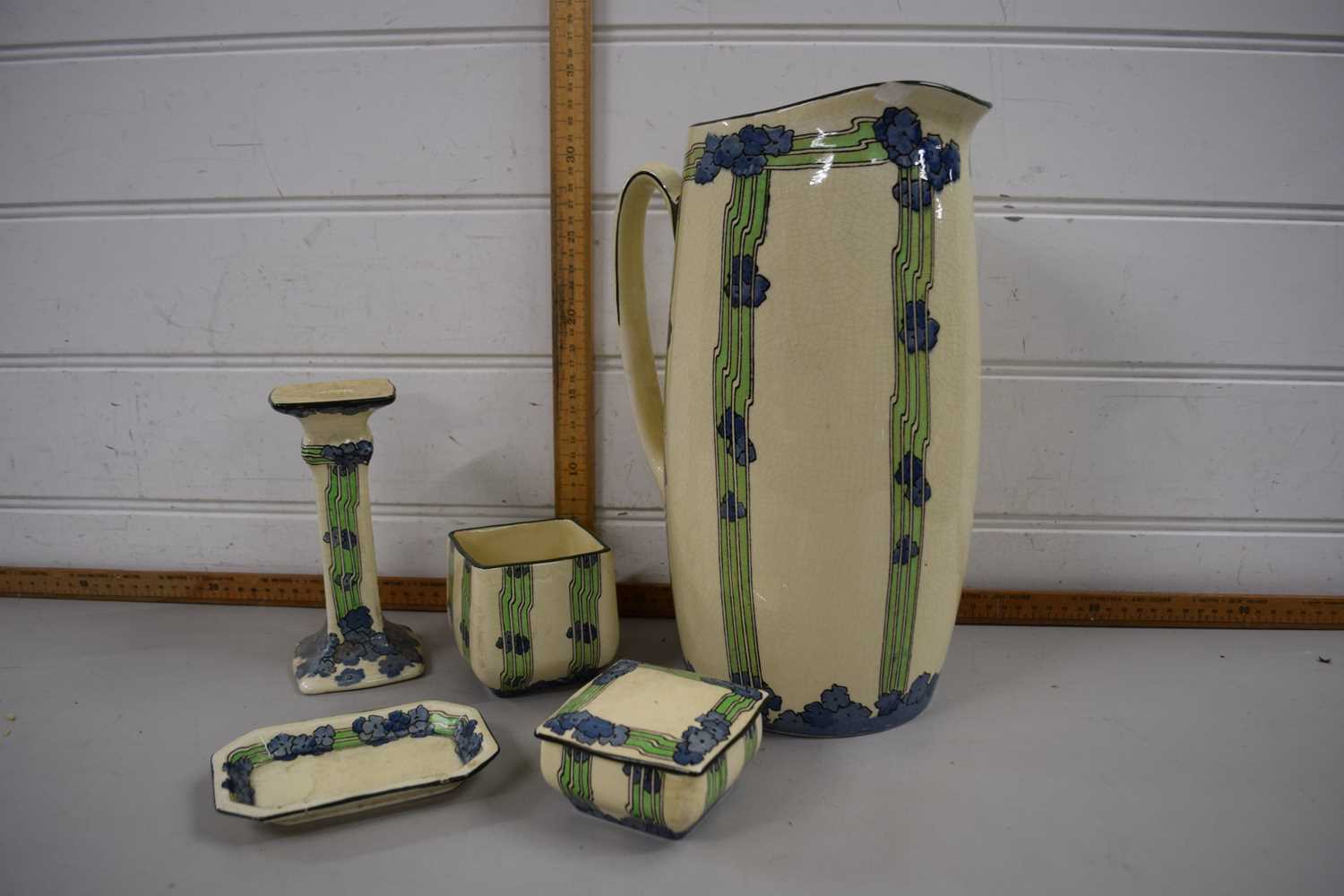 Royal Doulton dressing table set with jug, candlestick, small box and cover, all decorated in Art